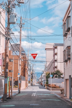 a red street sign hanging from the side of a building