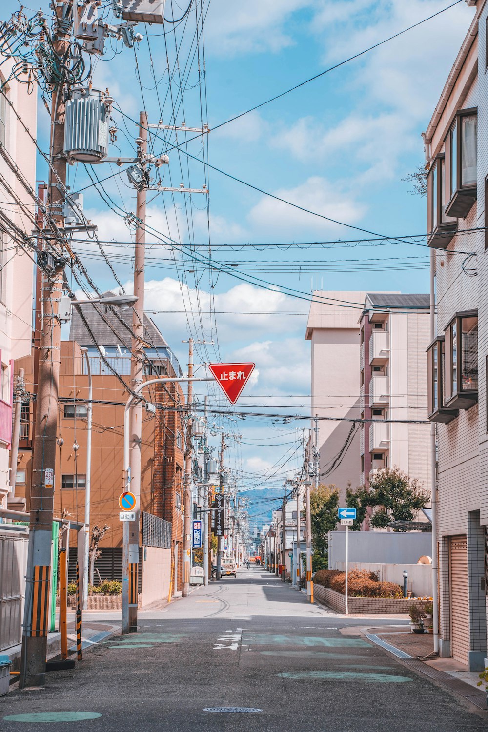 a red street sign hanging from the side of a building