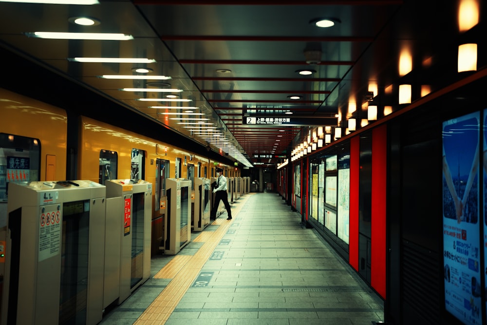 a subway station with a row of machines