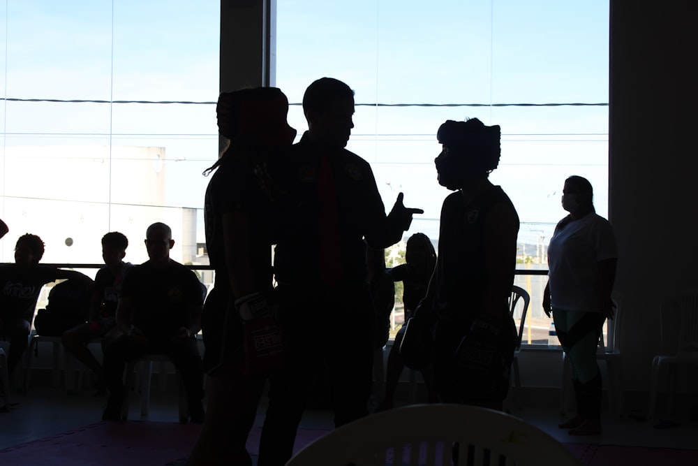 a group of people standing in front of a window