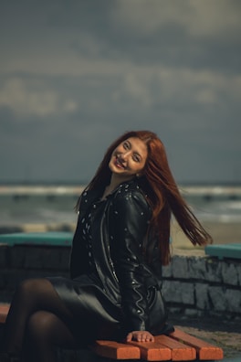 A senior woman smiling warmly while sitting on a bench overlooking Mount Tamalpais.