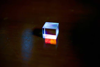 a small white cube sitting on top of a wooden table