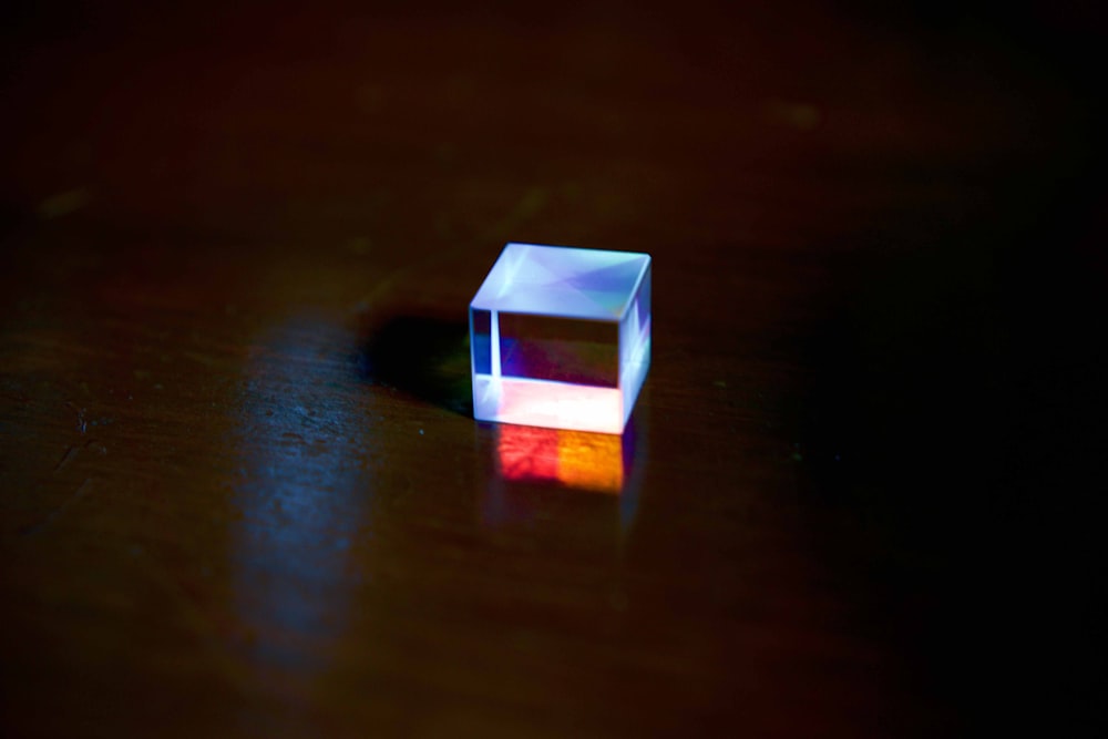 a small white cube sitting on top of a wooden table