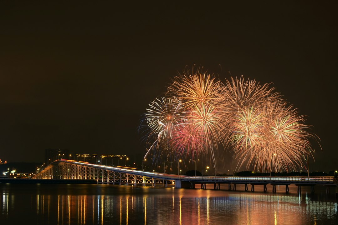 fireworks are lit up in the night sky over the water, Fireworks Display in Macao