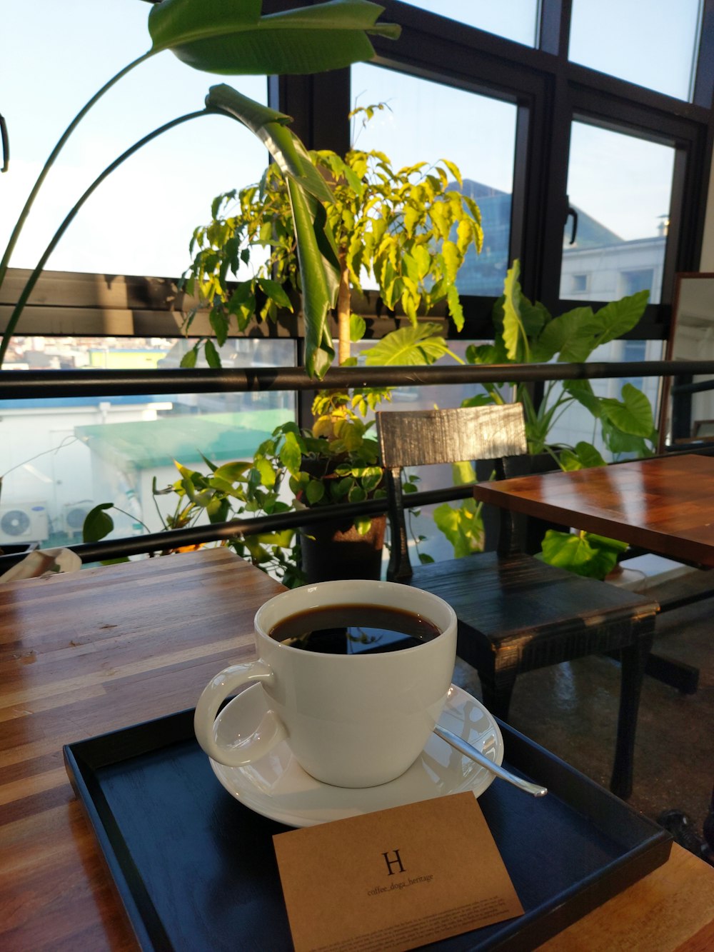 a cup of coffee sitting on top of a wooden table