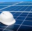 a white hard hat sitting on top of a solar panel