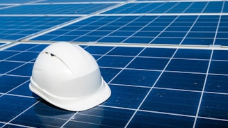 a white hard hat sitting on top of a solar panel