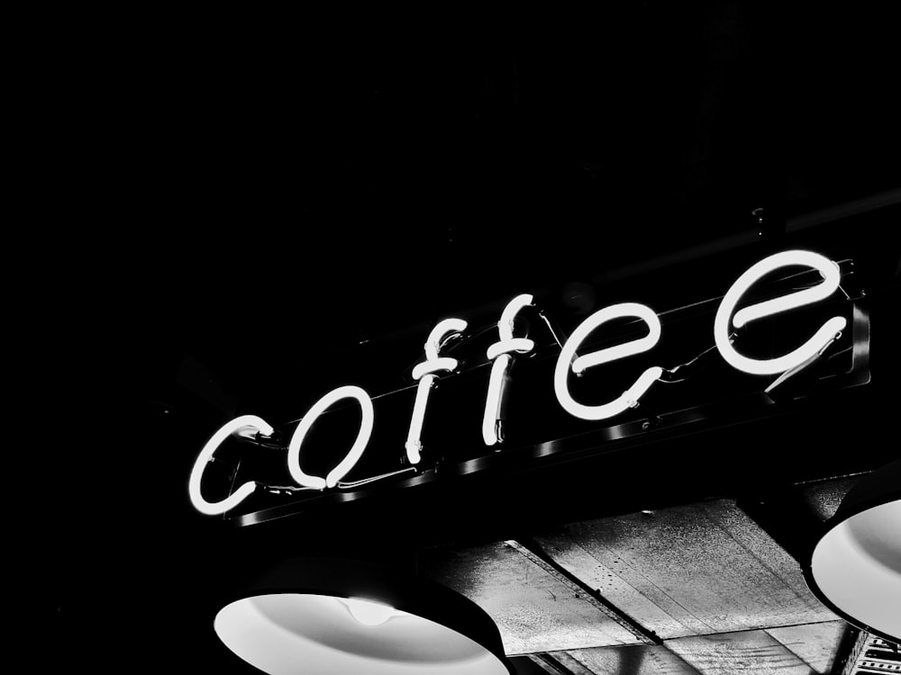 a black and white photo of a coffee shop sign