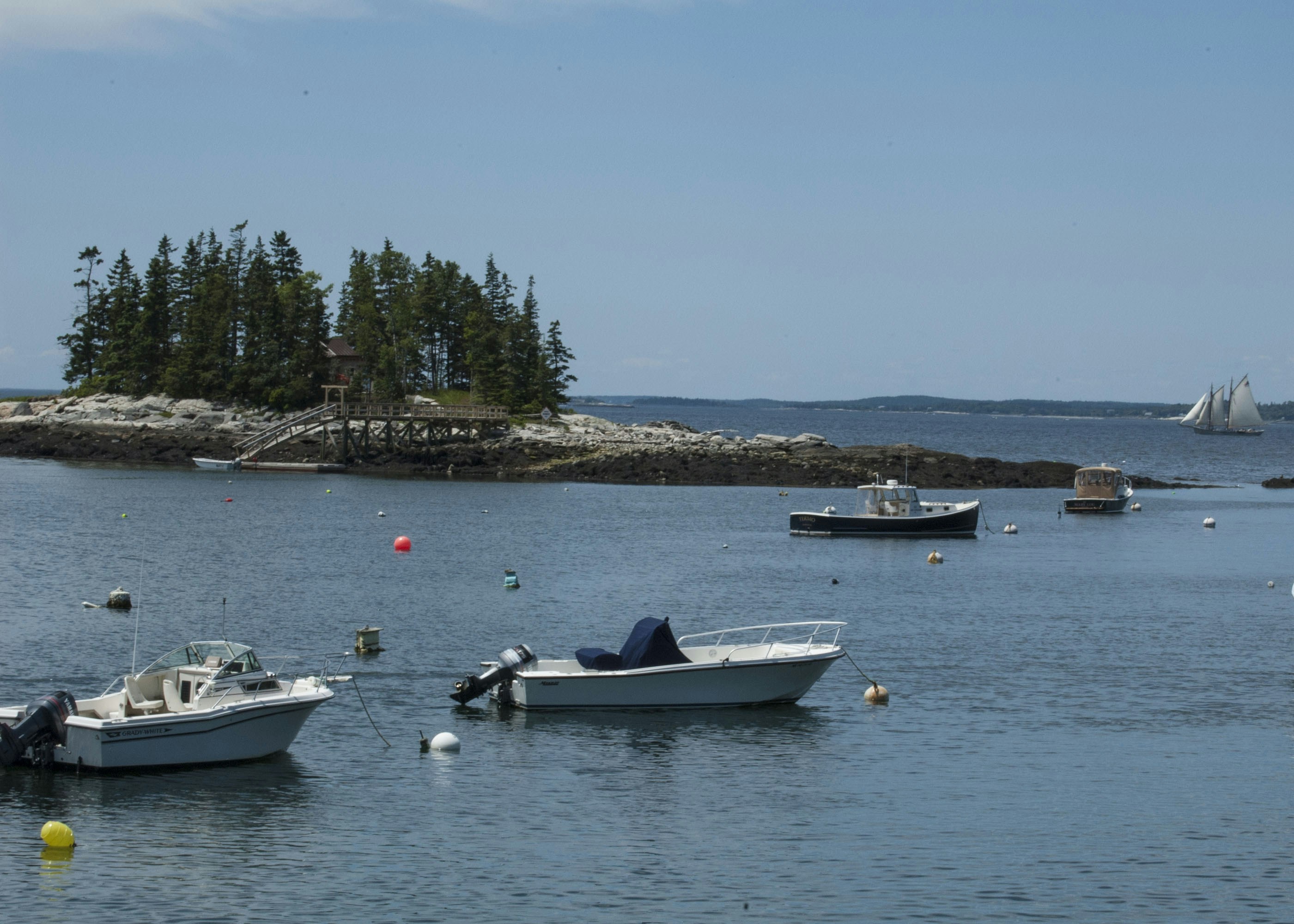 a group of boats floating on top of a lake