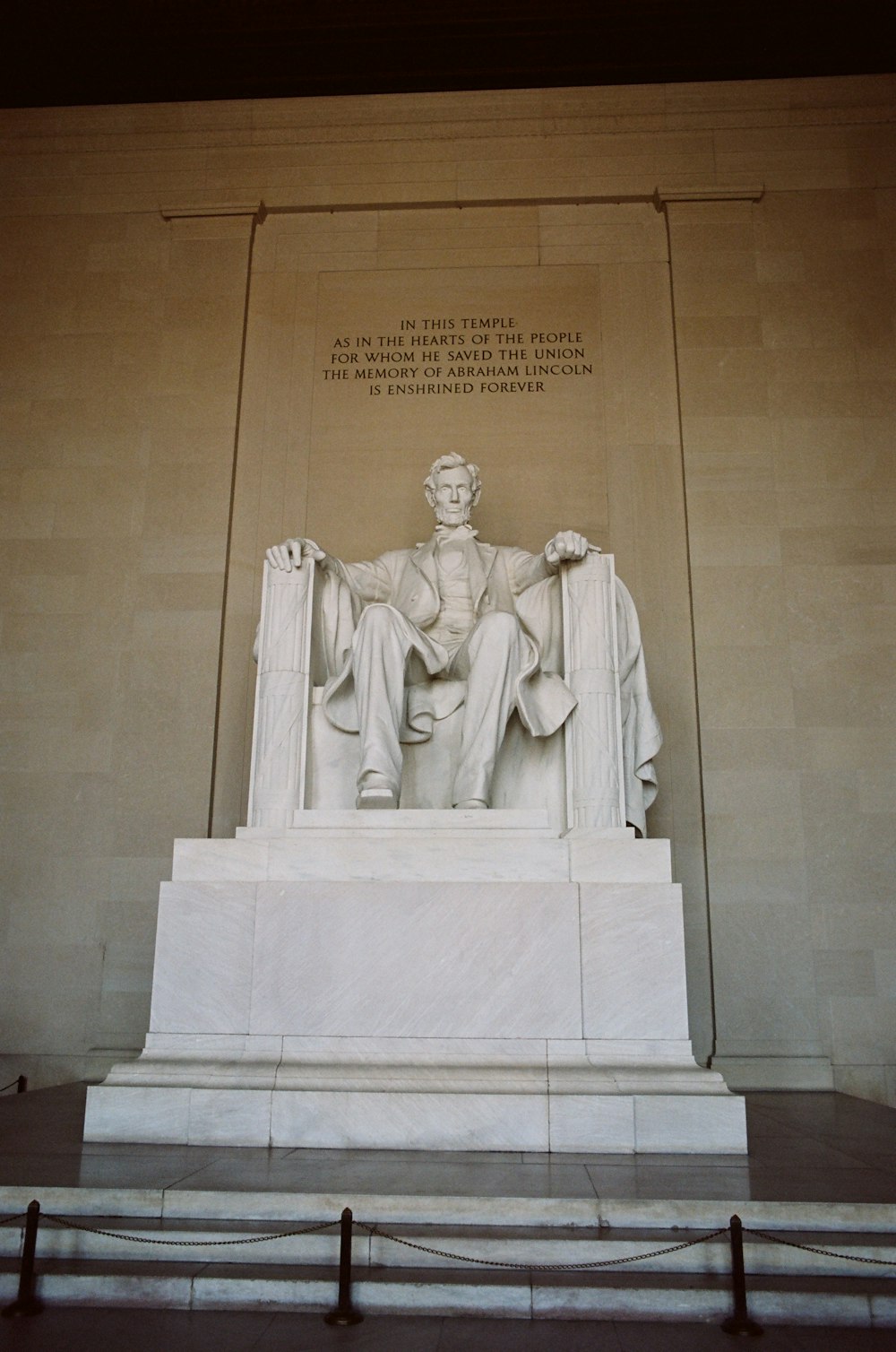 a statue of abraham lincoln in front of the lincoln memorial