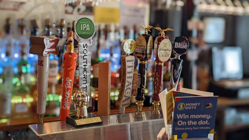 Row of beer taps, representative photo — not the actual venue