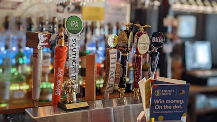 Row of beer taps, representative photo — not the actual venue