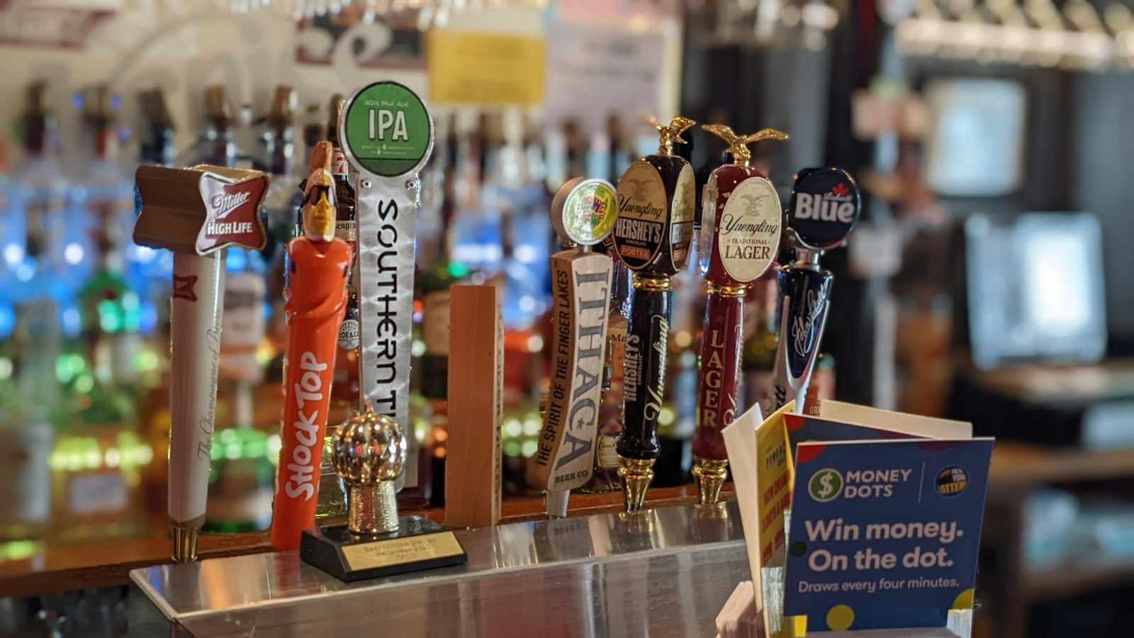 A row of beer taps on a bar