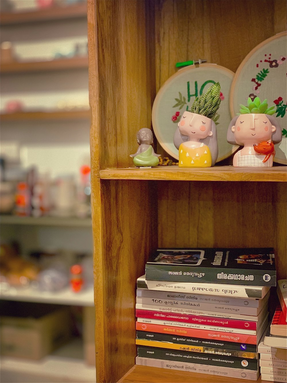 a book shelf with a couple of figurines on top of it