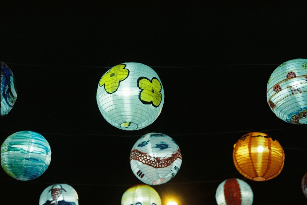 a bunch of paper lanterns hanging from a line