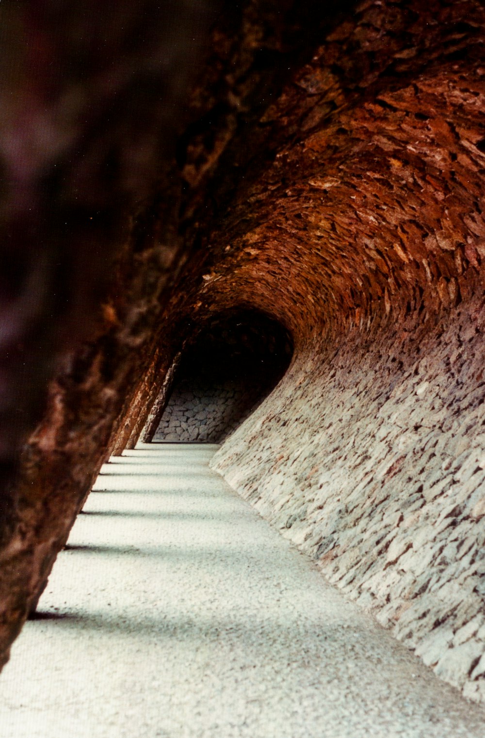 a long narrow tunnel with a clock on the side of it