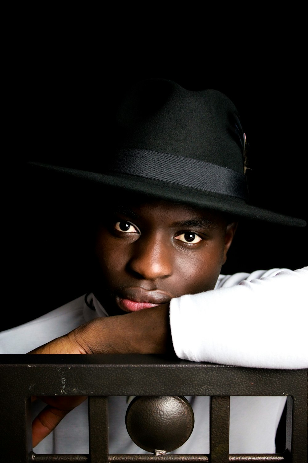 a man wearing a black hat and a white shirt