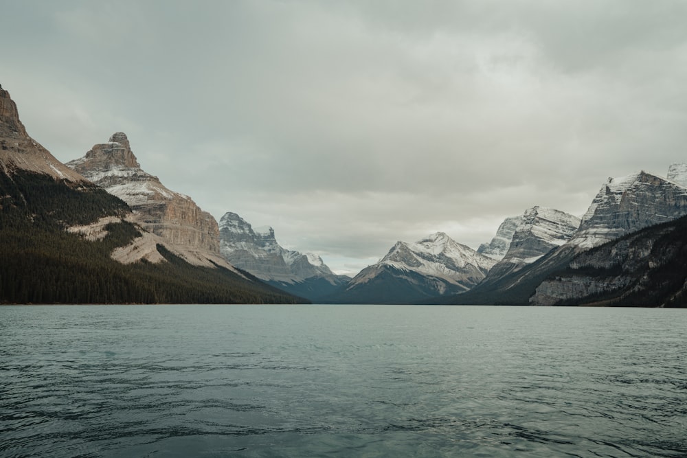 a body of water with mountains in the background