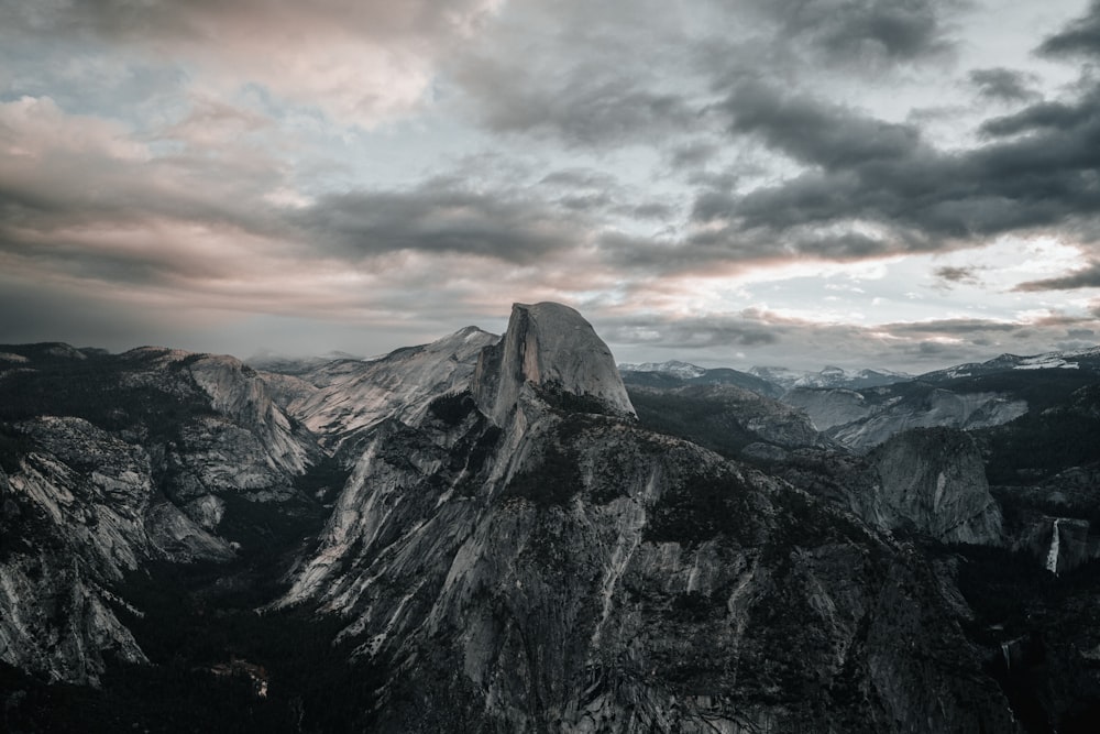 a view of the top of a mountain with a cloudy sky