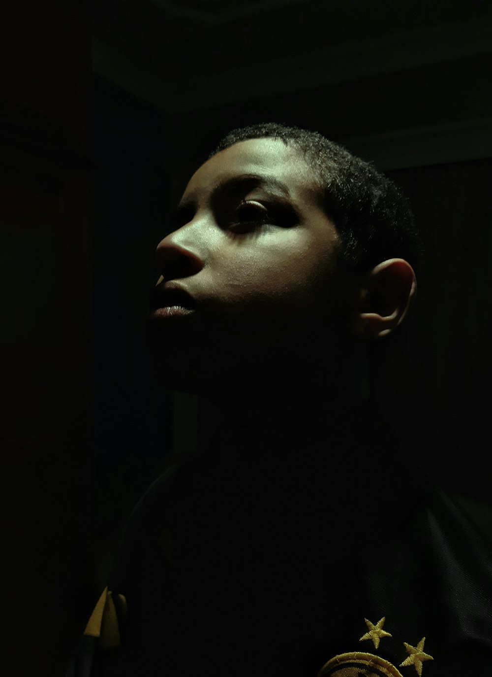 a man with a star on his collar in a dark room