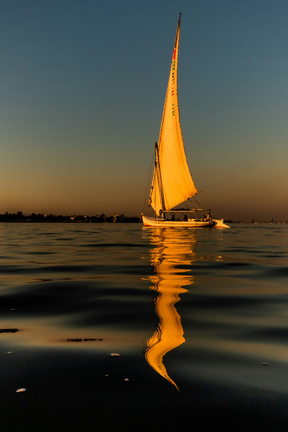a sailboat sailing on a body of water