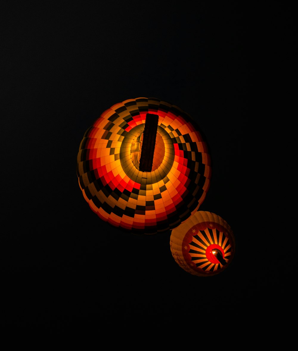 a couple of hot air balloons in the dark
