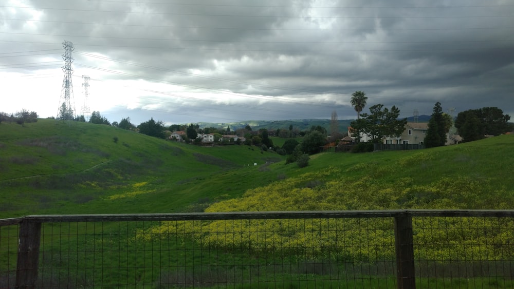 a lush green hillside covered in lots of clouds