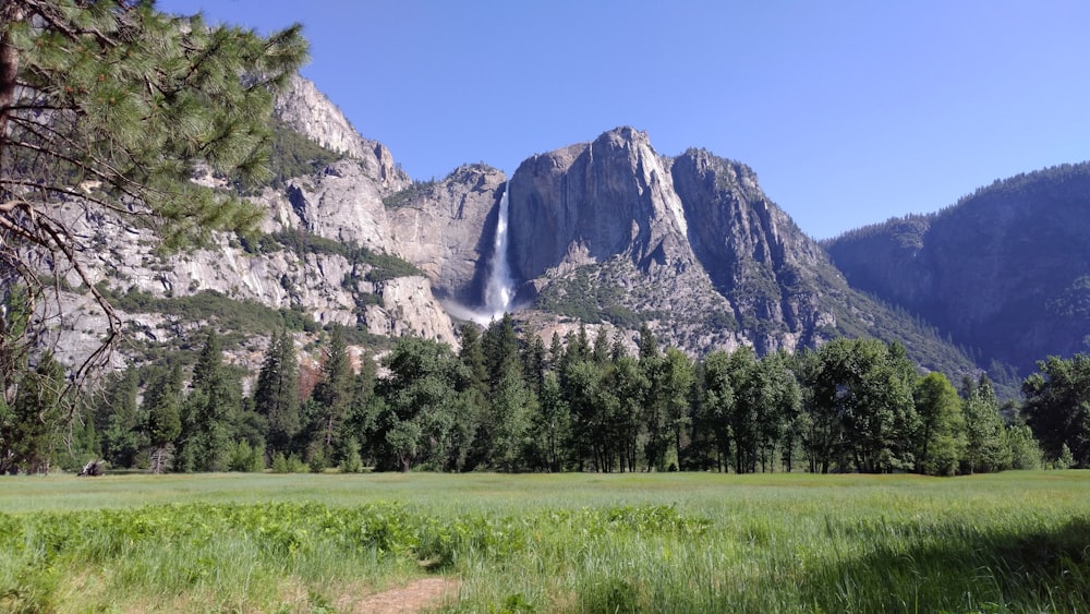 a view of a mountain with a waterfall in the distance