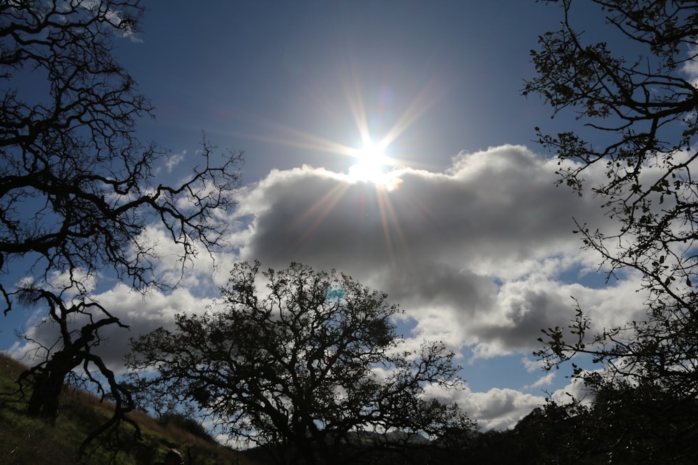 the sun is shining through the clouds in the sky