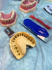 a table topped with fake teeth and dental tools