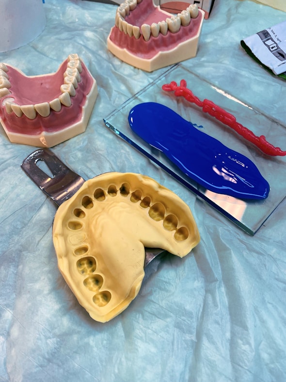 a table topped with fake teeth and dental tools