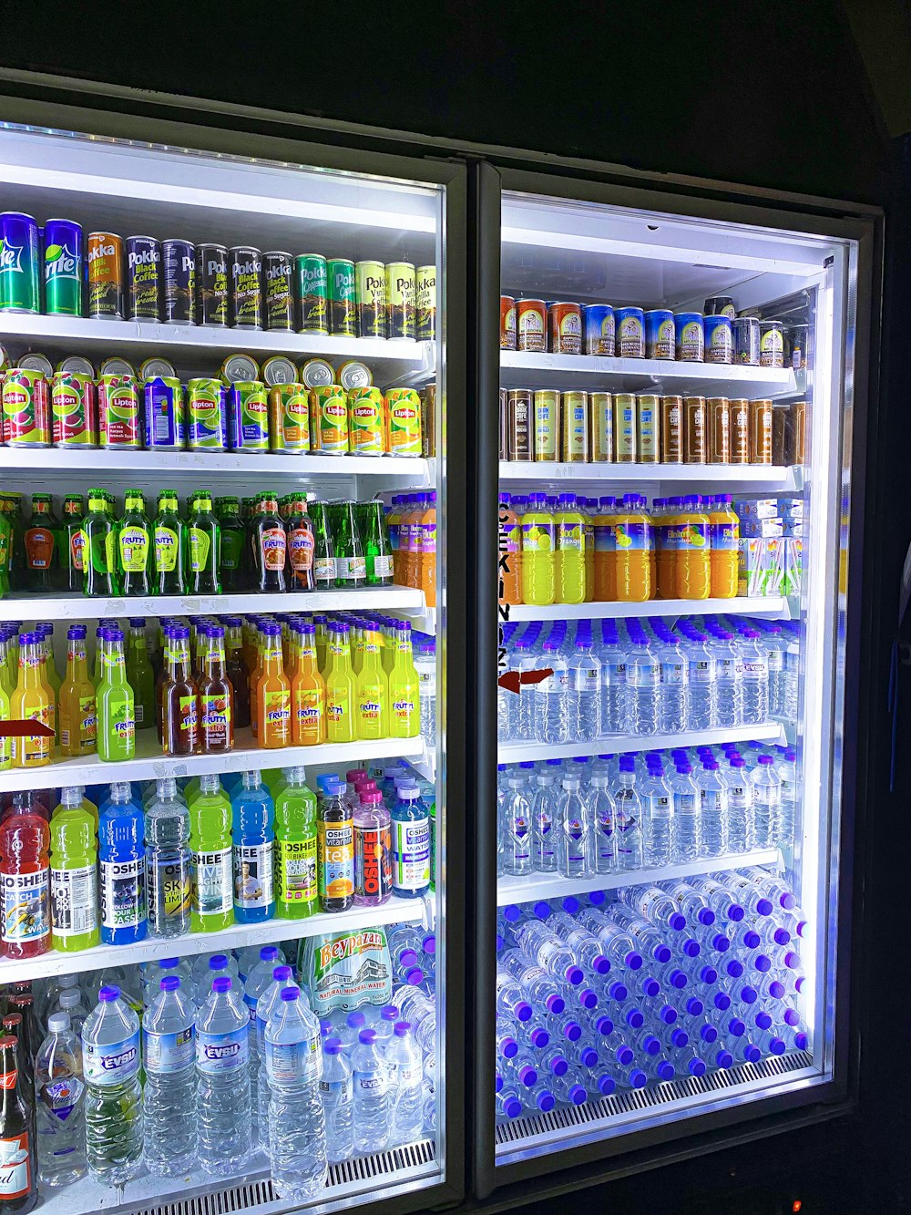 a refrigerator filled with lots of different types of drinks