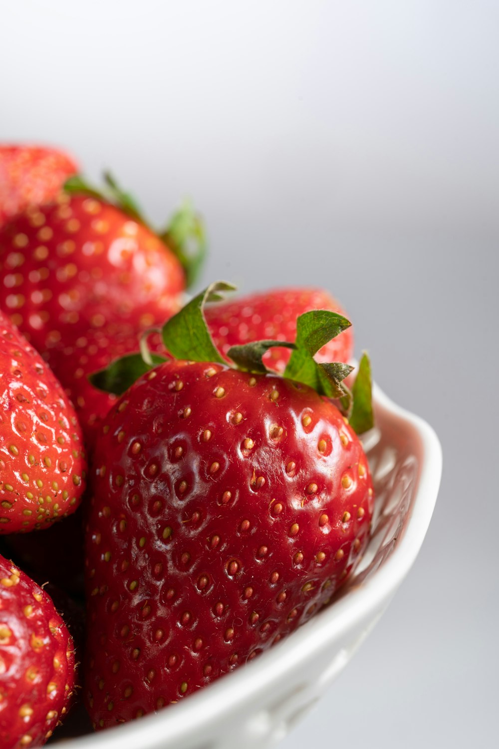 a close up of a bowl of strawberries