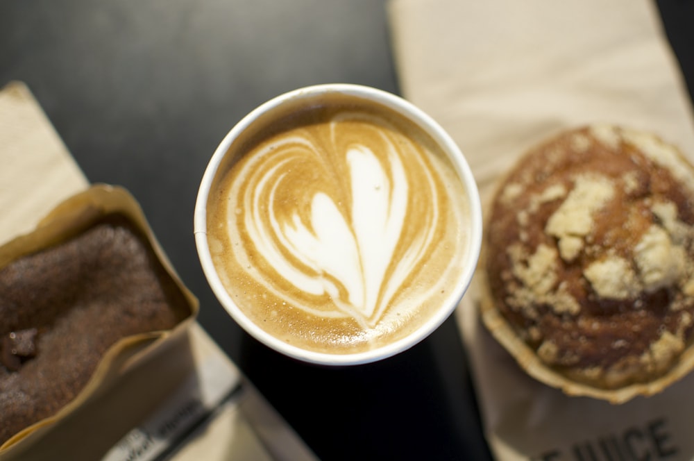 a cup of coffee and a pastry on a table