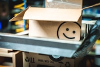 a cardboard box with a smiley face drawn on it