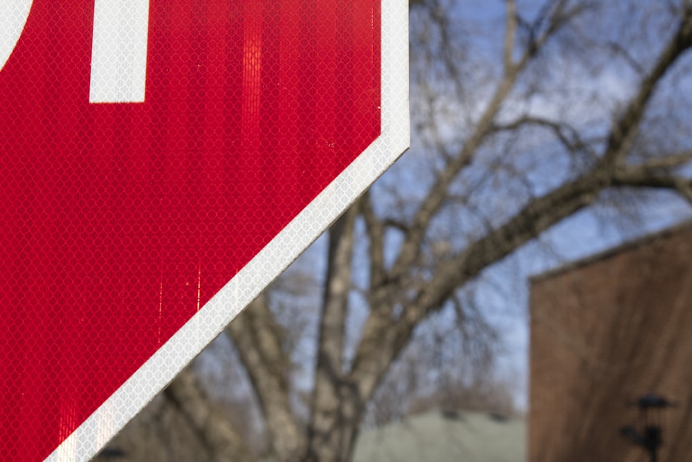 a close up of a stop sign with a building in the background