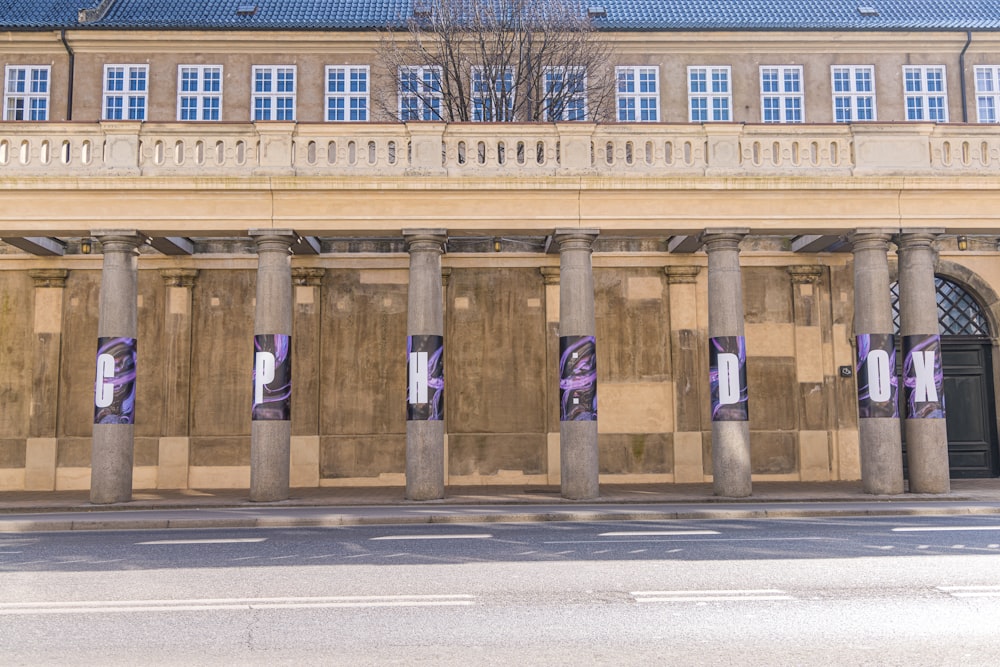 a building with columns and a clock on the side of it