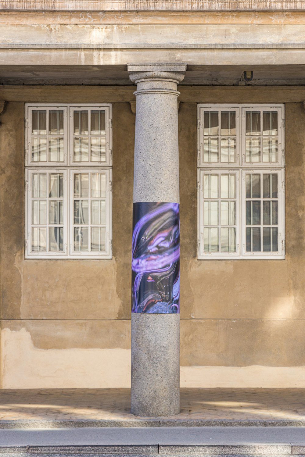 a tall pillar sitting in front of a building