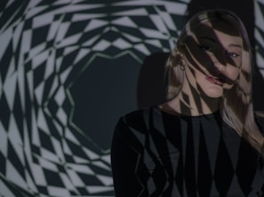 Abstract shadows and light play on a black backdrop, capturing the essence of body as a sensory space.