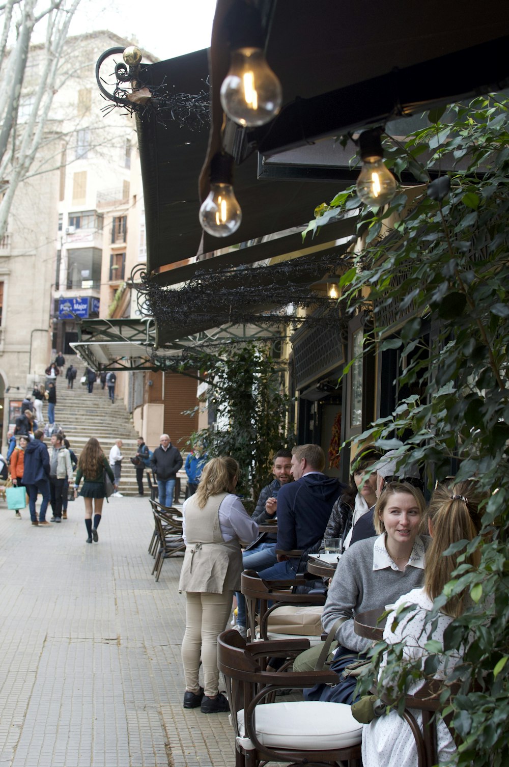 a group of people sitting outside of a restaurant