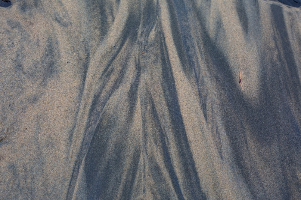 a surfboard that is laying on the sand