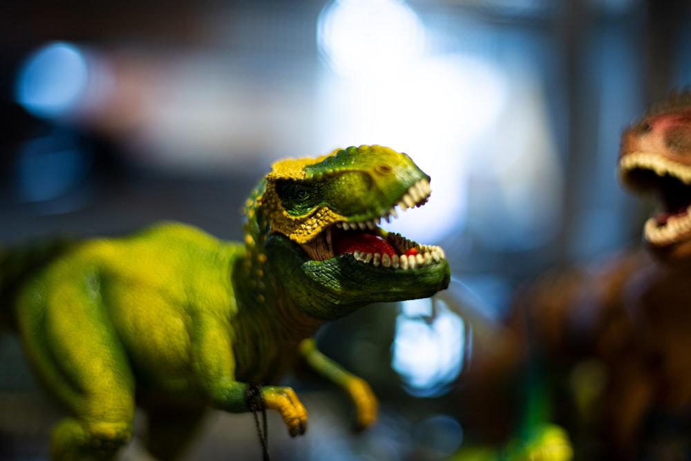 a close up of a toy dinosaur with its mouth open