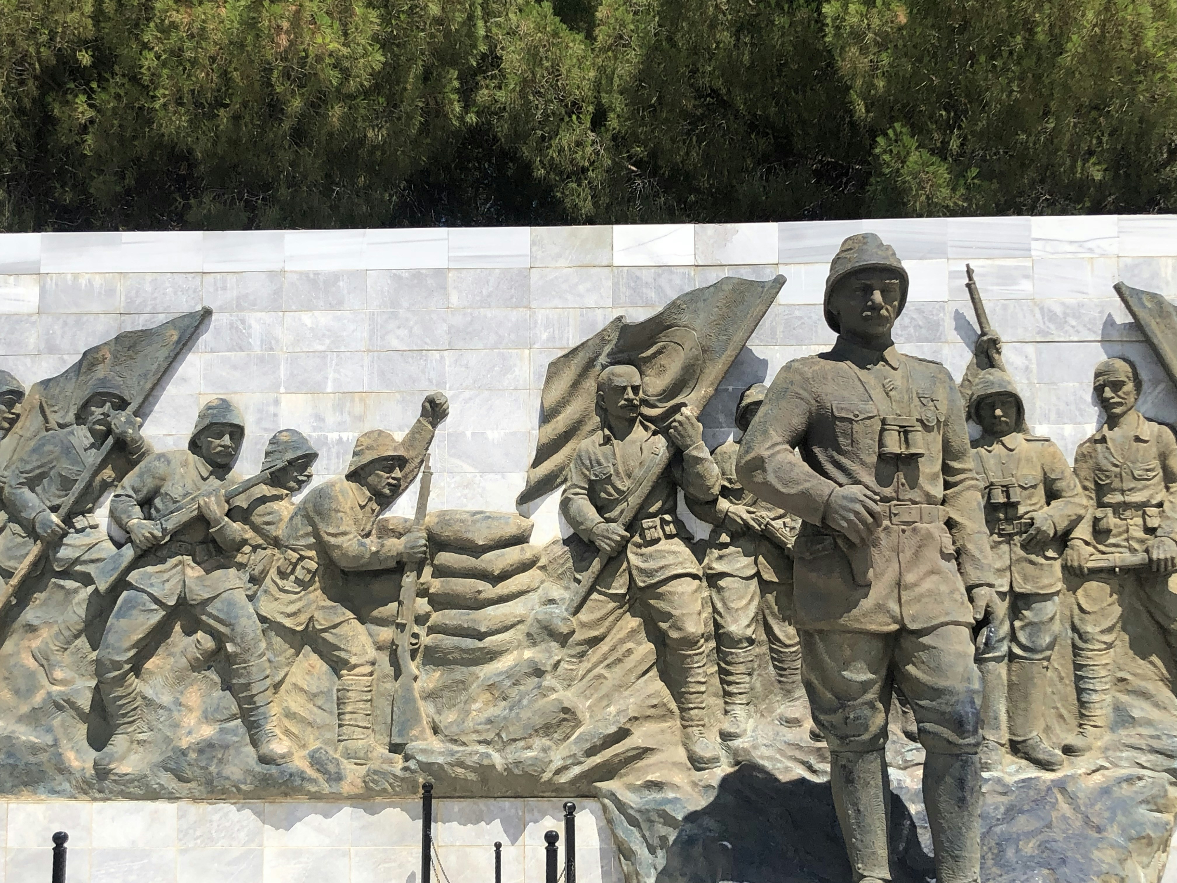 a statue of a group of soldiers holding flags