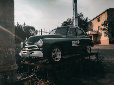 A classic vintage car displayed in a scenic outdoor setting.