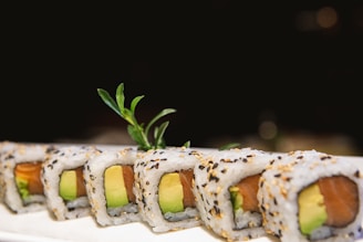 a plate of sushi with a garnish on top of it