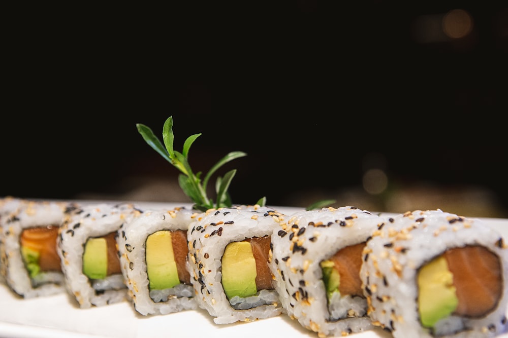 a plate of sushi with a garnish on top of it