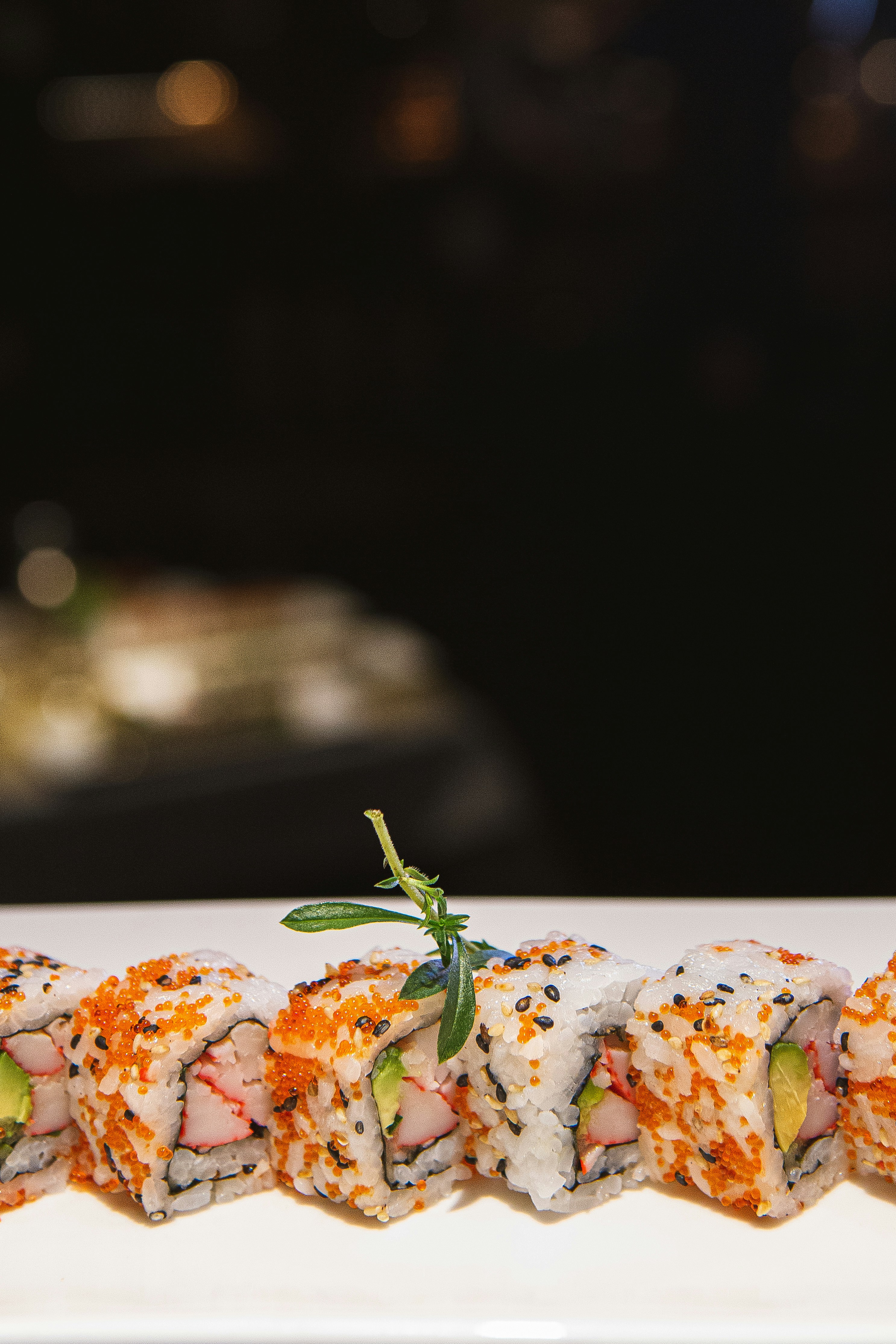 A white plate topped with sushi covered in sauce photo – Free Sushi