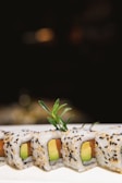 An elegant close-up of a sushi roll with delicate garnishes.
