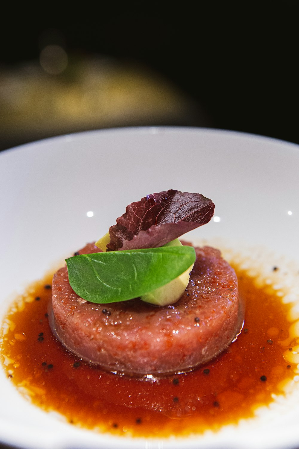 a small dish of food on a white plate