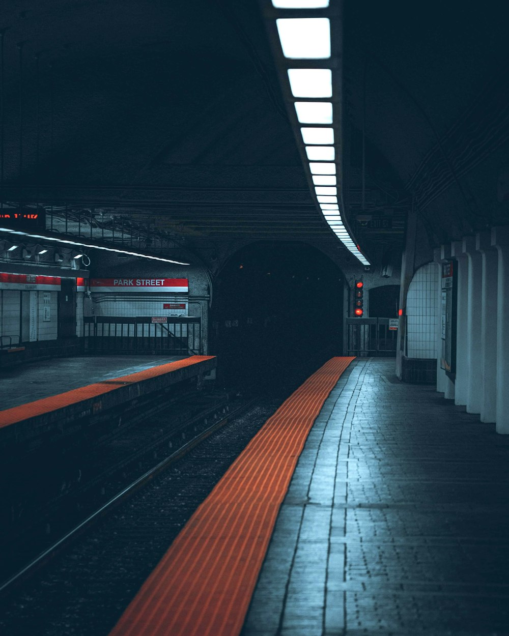 a train station with a train pulling into the station